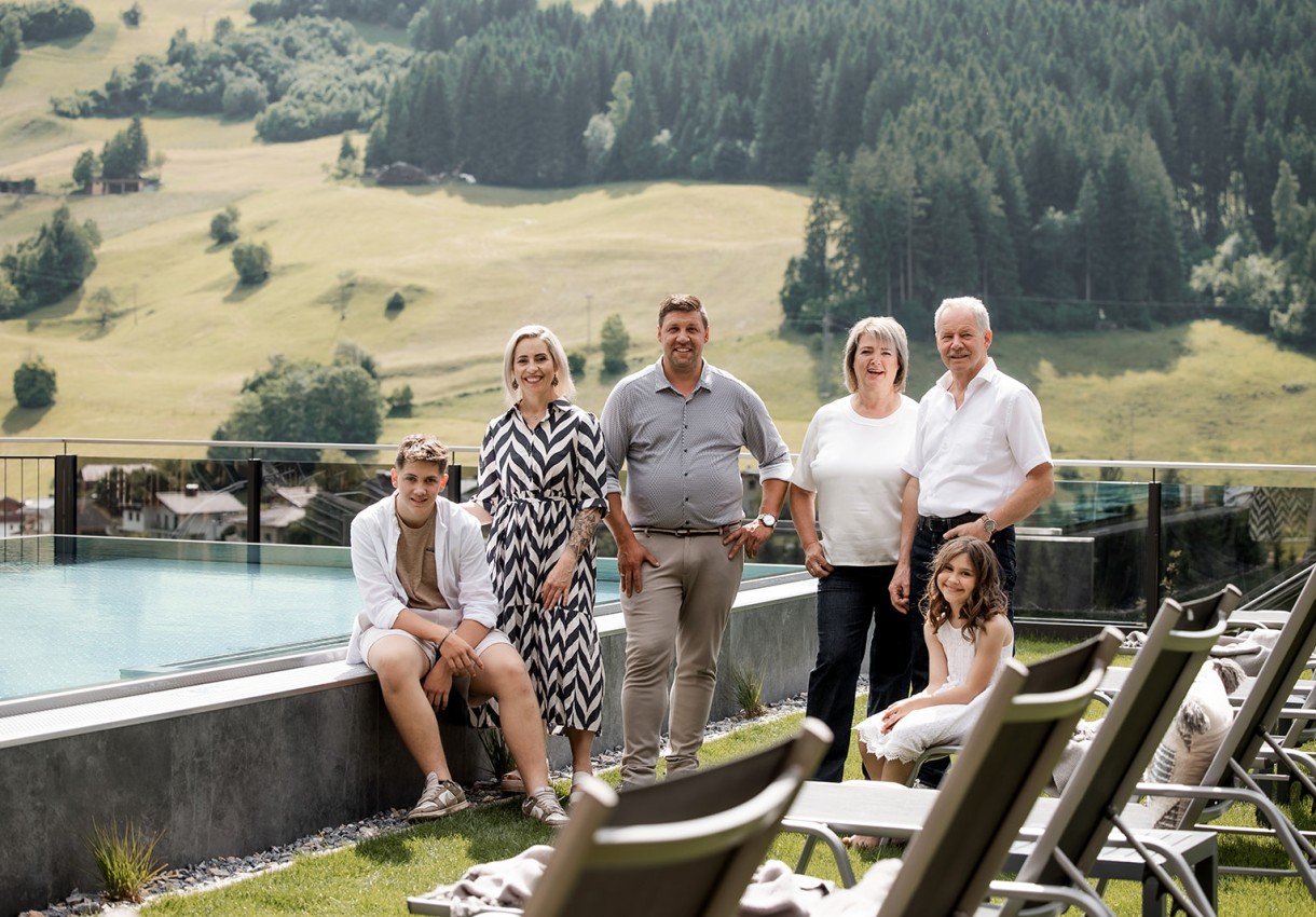 Familie Aichhorn posiert vor einer malerischen Berglandschaft